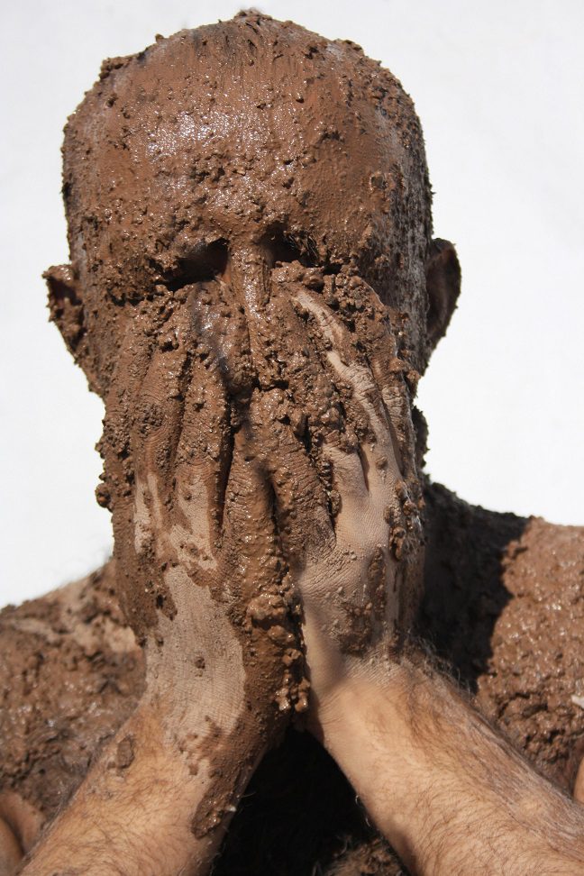 Man covered in mud