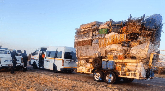 Overloaded trailer at the back of a van